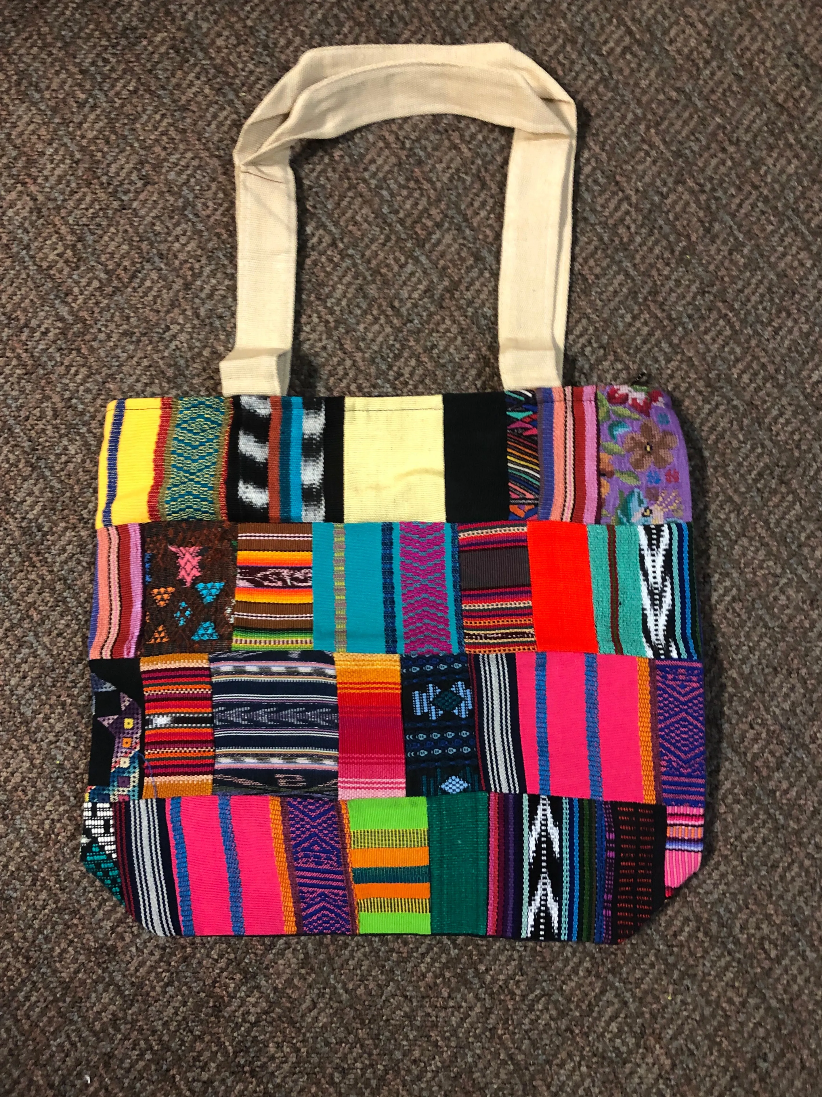 Handwoven Guatemalan cotton patches fashioned into a sturdy shoulder bag, fully lined with one zipper pocket. 15” x 17”