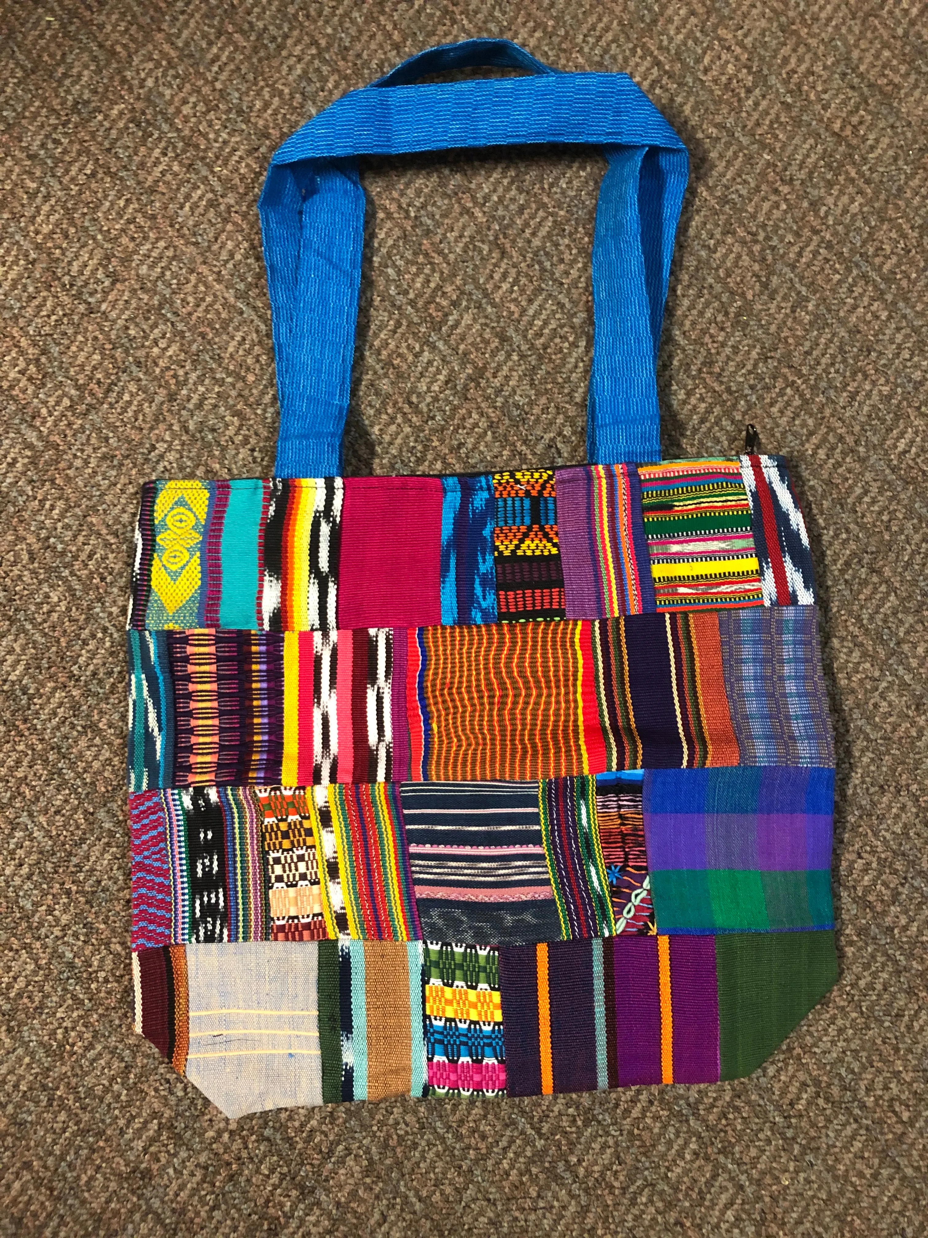 Handwoven Guatemalan cotton patches fashioned into a sturdy shoulder bag, fully lined with one zipper pocket. 15” x 17”